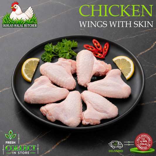 Raw chicken wings with skin arranged on a black plate, garnished with lemon slices, parsley, and red chili slices, on a dark marble-style background. Text reads 'CHICKEN WINGS WITH SKIN' and shows the Ikhlas Halal Butcher branding.