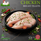 Three raw chicken breast fillets seasoned with herbs and red pepper flakes, presented on a black plate with tomatoes, garlic, and chili peppers on a dark stone surface. Text overlays read 'CHICKEN BREAST FILLETS' and show the 'Ikhlas Halal Butcher' logo.
