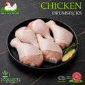 Raw chicken drumsticks arranged on a black plate with green chilies and a slice of ginger, set on a dark marble-style background. Large text reads 'CHICKEN DRUMSTICKS,' with the Ikhlas Halal Butcher logo in the top left and Fresh Collect in Store / 24 Hour Delivery badges at the bottom.