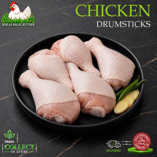 Raw chicken drumsticks arranged on a black plate with green chilies and a slice of ginger, set on a dark marble-style background. Large text reads 'CHICKEN DRUMSTICKS,' with the Ikhlas Halal Butcher logo in the top left and Fresh Collect in Store / 24 Hour Delivery badges at the bottom.